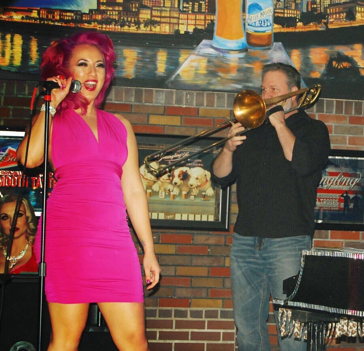 Jeff Adams on stage with vocalist